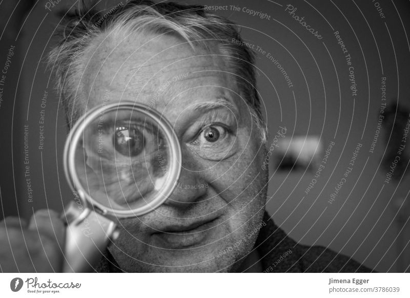 older man looks through magnifying glass Man Magnifying glass Enlarged Eyes Looking Lens Glass Investigate Search Human being Detective Curiosity Observe