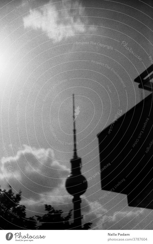 TV tower slightly sloping and building part on the right Analog analog photography Analogue photo Television tower Clouds leaves Sky Exterior shot