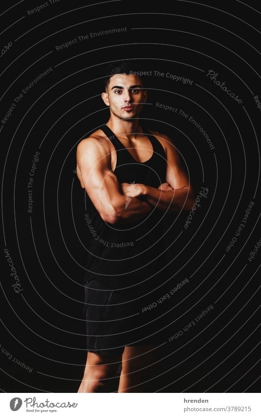 muscular man on a black background person athlete sport muscle fitness torso strength bodybuilder male young healthy power strong chest training bicep athletic