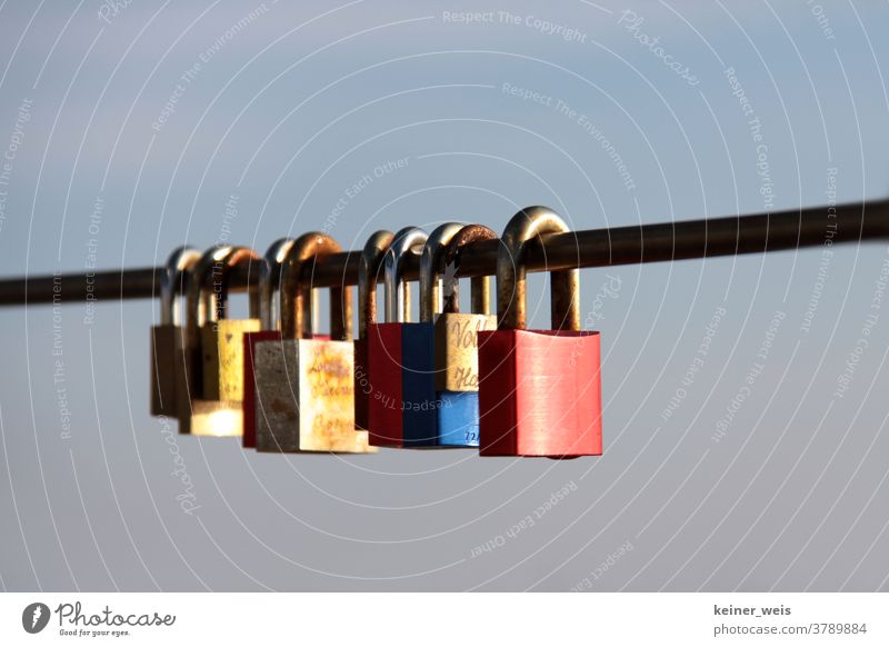 A row of love locks on a metal railing Love padlock Love Locks Many Row Colour photo Deserted Exterior shot Romance Loyalty Happy Together Heart Emotions