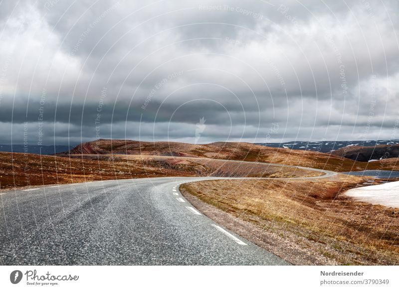Lonely country road over the mountains of Varanger in Norway Street Loneliness mysticism Curve Transport fjell High mountain region Asphalt Grass treeless