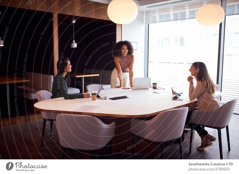 Three Businesswomen Having Socially Distanced Meeting In Office During Health Pandemic business women in business businesswomen meeting social distancing