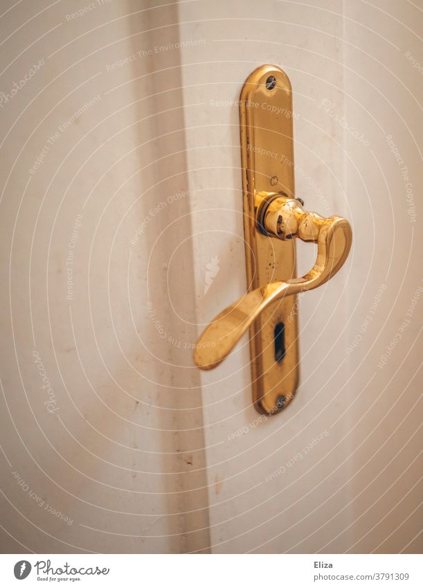 White door with gold door fittings. Door handle and door lock. door handle Door lock golden Old Old building Entrance Keyhole Wooden door