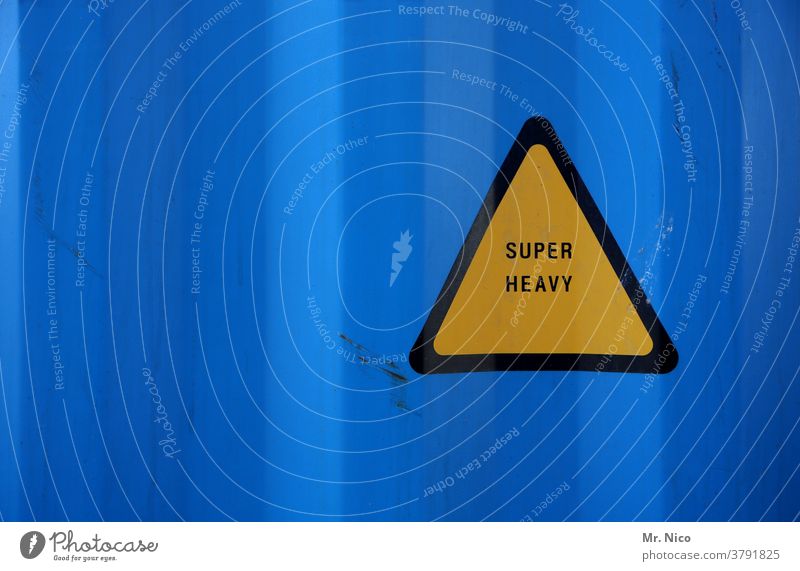 very heavy yellow triangle in front of blue background heavyweight Heavy Signs and labeling Signage Yellow Blue Triangle Warning sign Warning label Container