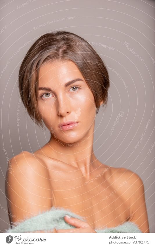 Woman with short hair in studio model woman style tender appearance trendy charming female beauty sensual happy vogue individuality perfect bare shoulders