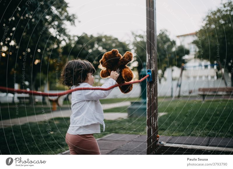 Little girl playing with Teddy bear at playground Playground Park Child childhood Bear Toys Cute Joy kid Small Infancy Playing Brown Colour photo Exterior shot
