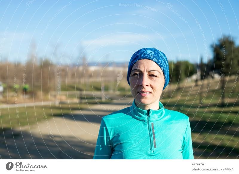 Portrait of mature runner woman with sport headband in the park fit nature old female aged lifestyle person training senior outdoors healthy elderly athletic