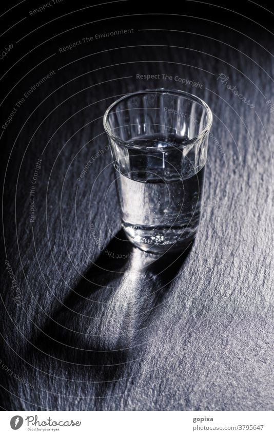 A glass of water with shadow Glass drinking glass Water Drinking water Mineral water Food food products Healthy Thirst Simple Dark darkness Sparse Shadow