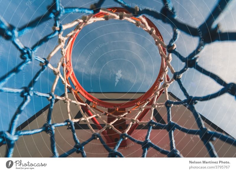 View from below of a basketball hoop. Abstract shot of a basketball net. blue Basketball Sports Net Playing Sky Exterior shot Ball sports Basketball basket Park