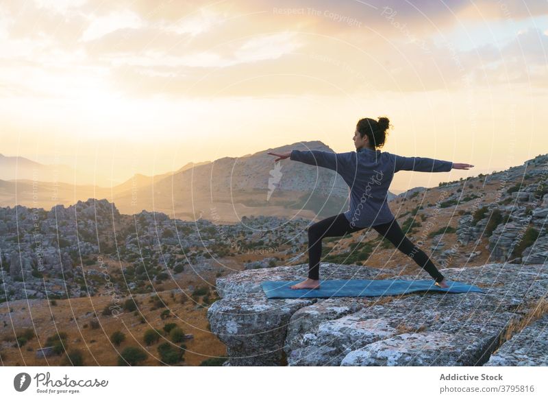 Meditative harmony and balance of a person, mental health. The woman is  slender, flexible body, practicing yoga exercise beautiful asana. Fitness  on the background of sunset. 27885859 Stock Photo at Vecteezy