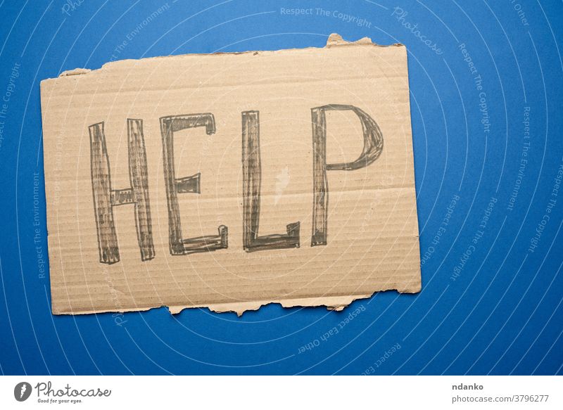 piece of cardboard with the inscription help, mutual assistance concept crisis homeless human information message one paper sign support symbol text torn word