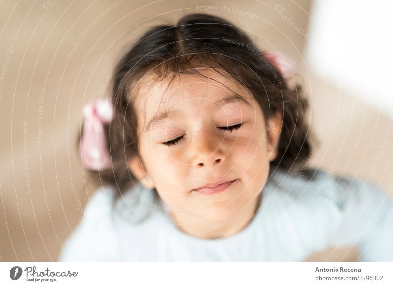 Little pretty girl portrait looking at camera with closed eyes three years old 3 years girls people illusion 3s face real people lifestyles child expression