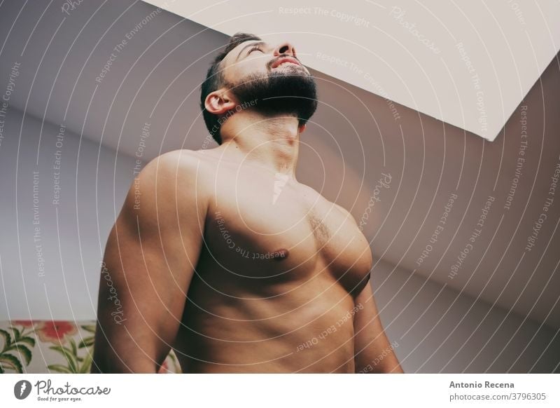 34 years old man looking window strong light torso looking up shirtless skylight men 30s male adult lifestyle person people bearded real people macho spanish