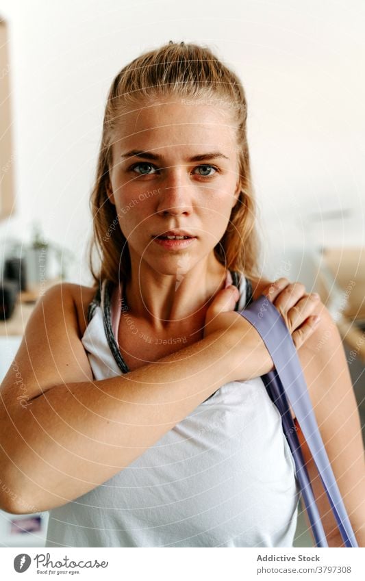 Pregnant woman doing exercises with dumbbells at home - a Royalty