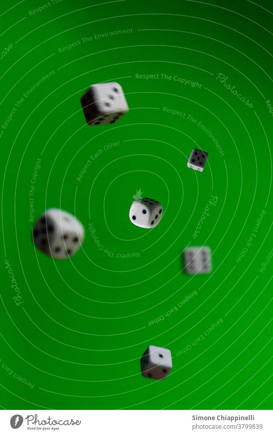 Throwing dice on green background Dice gambling Green Playing Throw dice Colour photo game Casino rolling dice Compulsive gambling