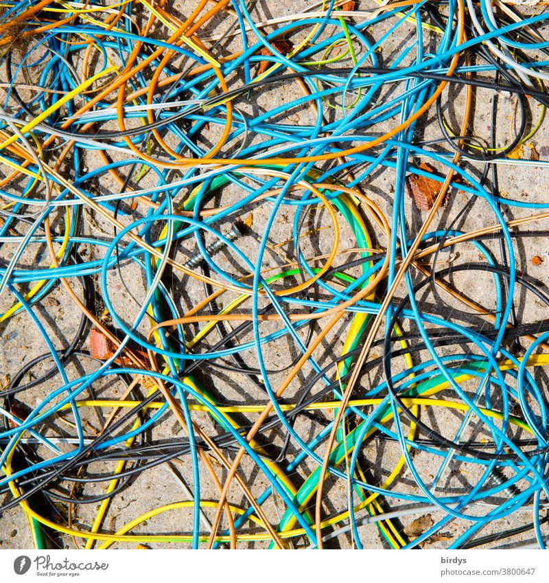 cable tangle, many loose, colorful cables lie confused on the floor Terminal connector Cable power cable variegated Many Muddled Electricity Chaos