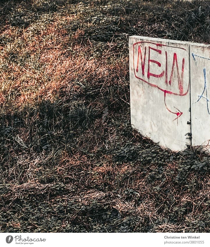 The word "NO" written with red paint is written on a low light concrete wall on a slope no Graffiti Colour Red Concrete wall Wall (building) Wall (barrier)