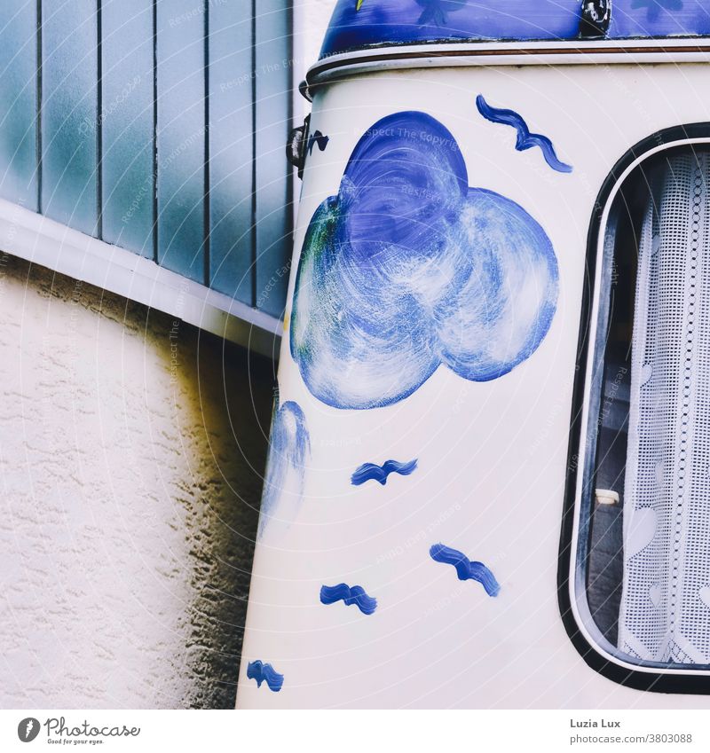 Excursion mood, blue and nostalgic: an old, beautifully painted caravan was parked close to a wall in matching colours Caravan Painted Clouds birds Drape