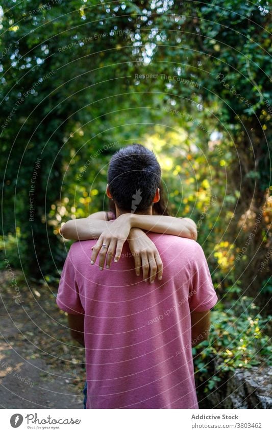 Anonymous couple hugging in lush forest embrace face to face bonding fondness amour tender valentine park romantic relationship nature together love affection