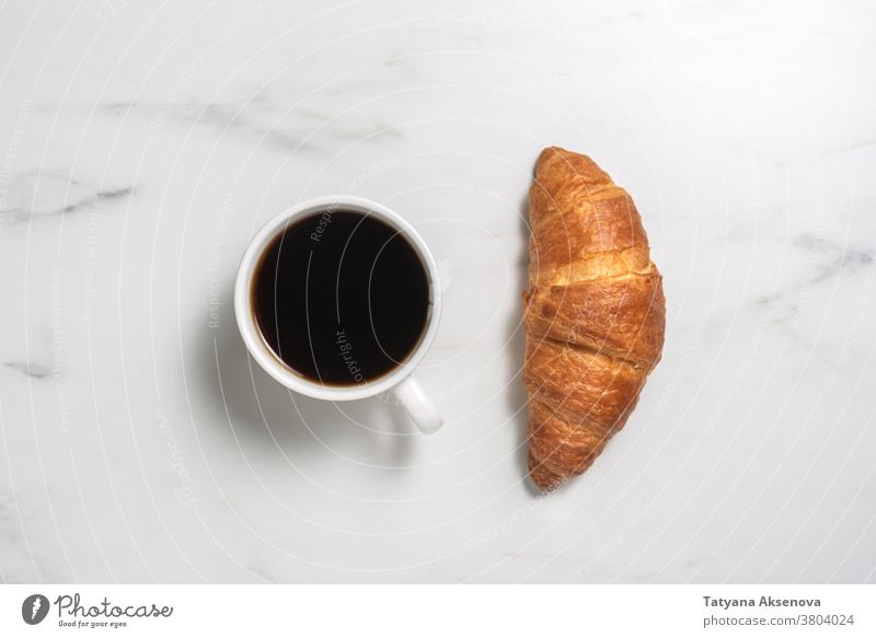Fresh baked croissant and coffee breakfast food french morning pastry espresso drink cup bakery cafe marble no people