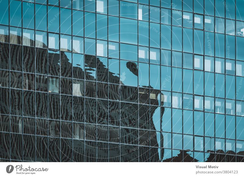 Cityscape silhouettes reflected on the glazed facade of an office building abstract reflection windows urban architecture edifice frontage structure geometric