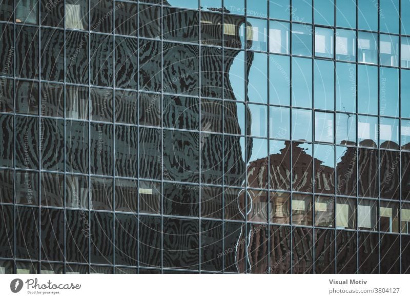 Cityscape silhouettes reflected on the glazed facade of an office building abstract reflection windows urban architecture edifice frontage structure geometric
