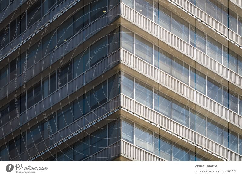 Symmetrical view of the corner of a residential building covered with a mesh facade windows urban architecture balconies edifice structure geometric abstract