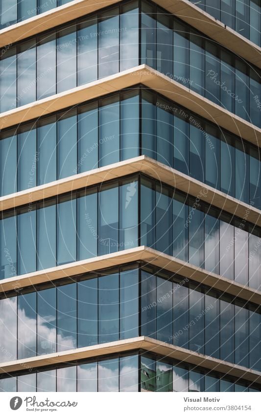 Symmetrical view of the corner of an office building with vertical glazed windows facade symmetrical abstract urban architecture edifice frontage structure