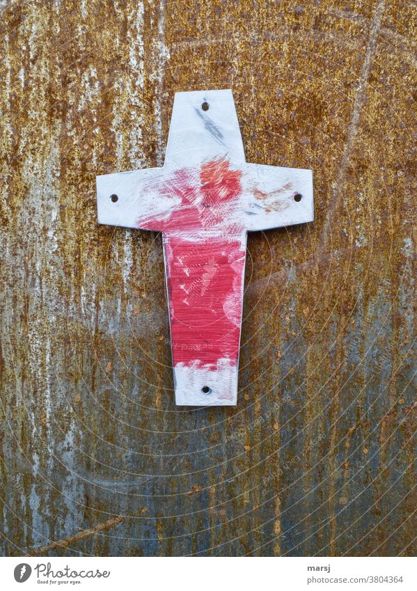 Red smeared cross against a rusty background Christian cross Religion and faith Crucifix Old Easter Good Friday corroded tranquillity Hope Symbols and metaphors