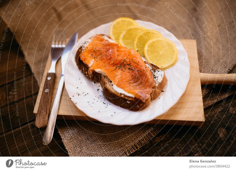 Smoked salmon with cheese toasted bread lemon and yogurt dip smoked smoked salmon cream cheese crostini prepared served slice plate dish table meal breakfast