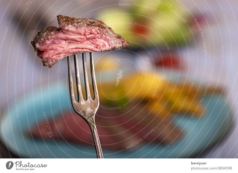 Disc steak on a fork Fork Rustic Steak Beef steak Resources Slice Sirloin Frying roasted Meat Juicy Cut Red Eating Raw Seldom background Plate Quality Dinner