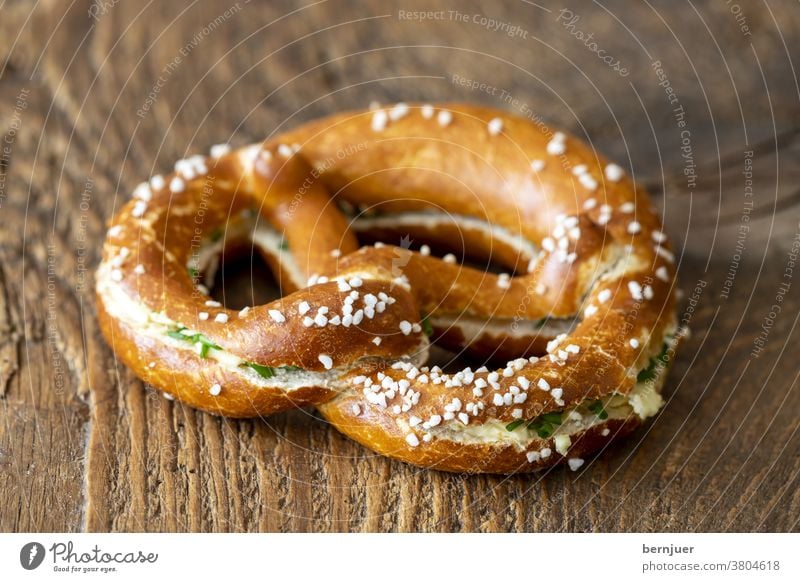 Bavarian pretzel with butter on wood Pretzel butter pretzel Butter Bread Germany Snack Fresh Breakfast Delicious Coffee background Meal snack Eating Table