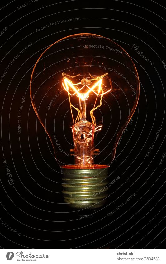 Incandescent lamp Bulb in front of black background light bulb Electric bulb Light Dark darkness stream Energy Electricity Energy industry Renewable energy