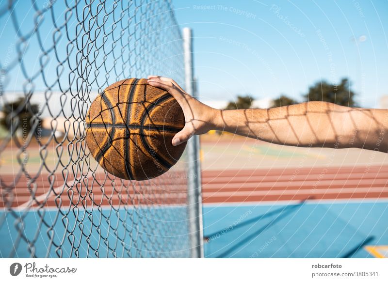 man playing basketball an outdoor court on the street. fun sport urban people cool men shot young game male adult jump hoop score competition leisure african