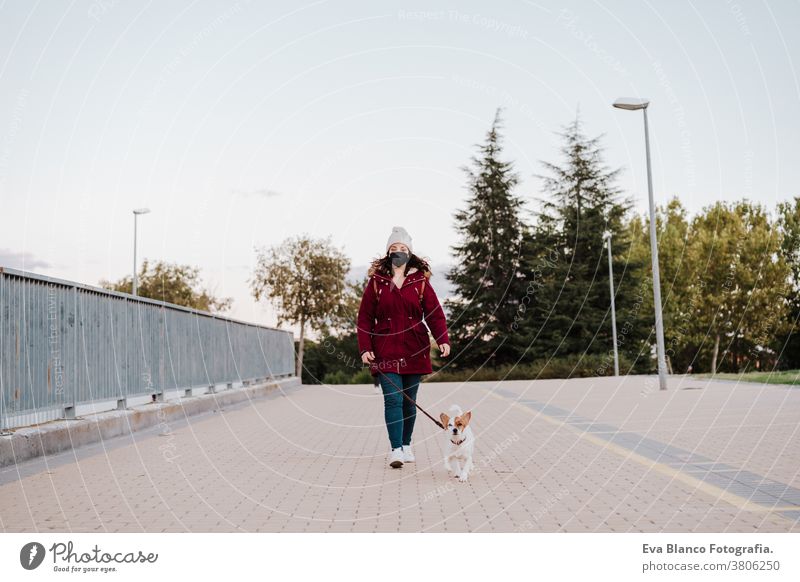 woman at the city walking with her adorable jack russell dog. Lifestyle outdoors allergic autumn care caucasian copy space corona coughing danger disease