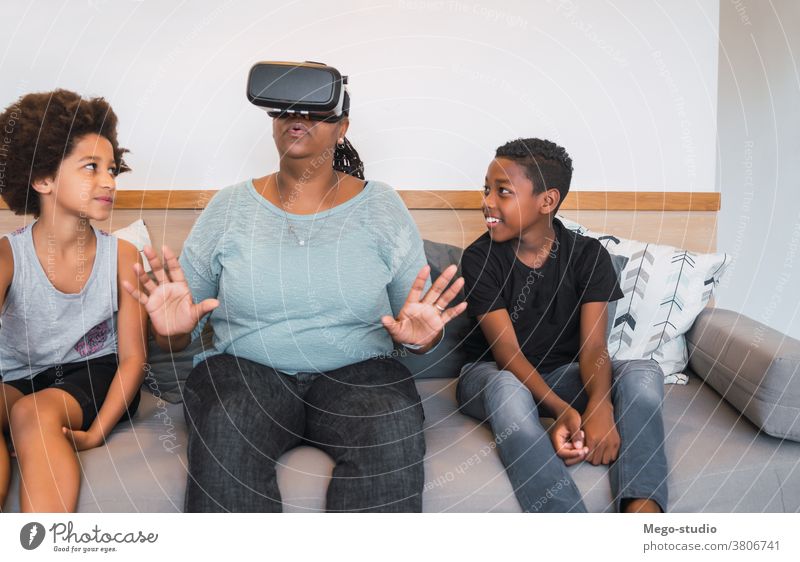 Grandmother and grandchildren playing together with VR glasses. grandparent reality virtual simulation modern device concept simulator virtual reality