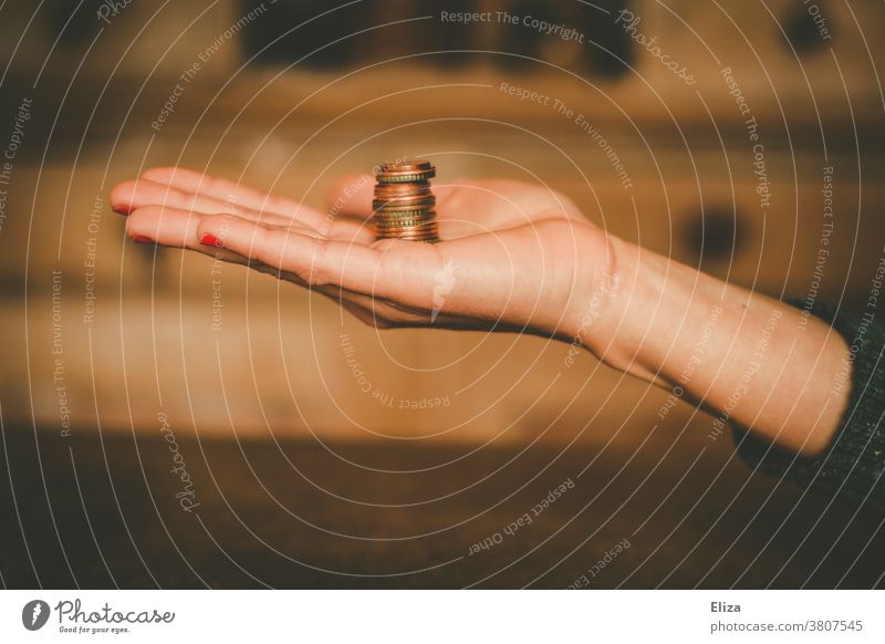 A woman holds a tower of change in her hand. Savings, money, finance. small change Coins Money Save Hand Tower Loose change Paying Little Woman investment