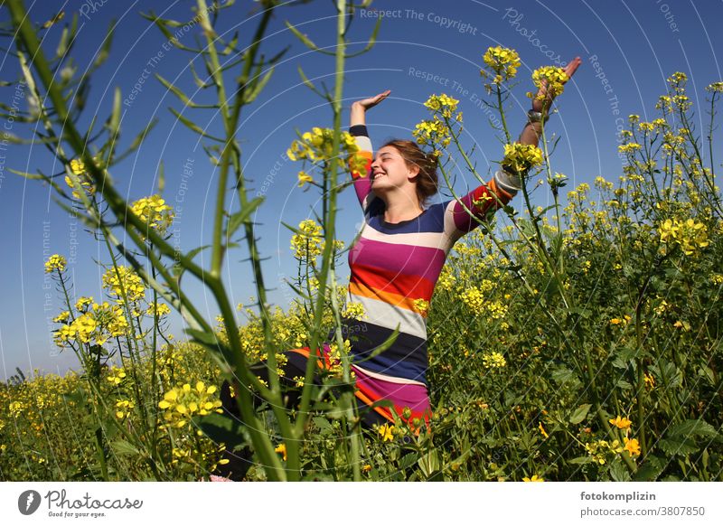 young woman jumping with arms up in a rape field Canola Canola field Field Optimism Young woman Woman Self-confidence Joie de vivre (Vitality) Happy pleased