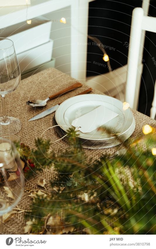 Holiday Gold place setting,  Christmas table with ornaments and natural pine branch on the livingroom home christmas thanksgiving menu food happy decoration