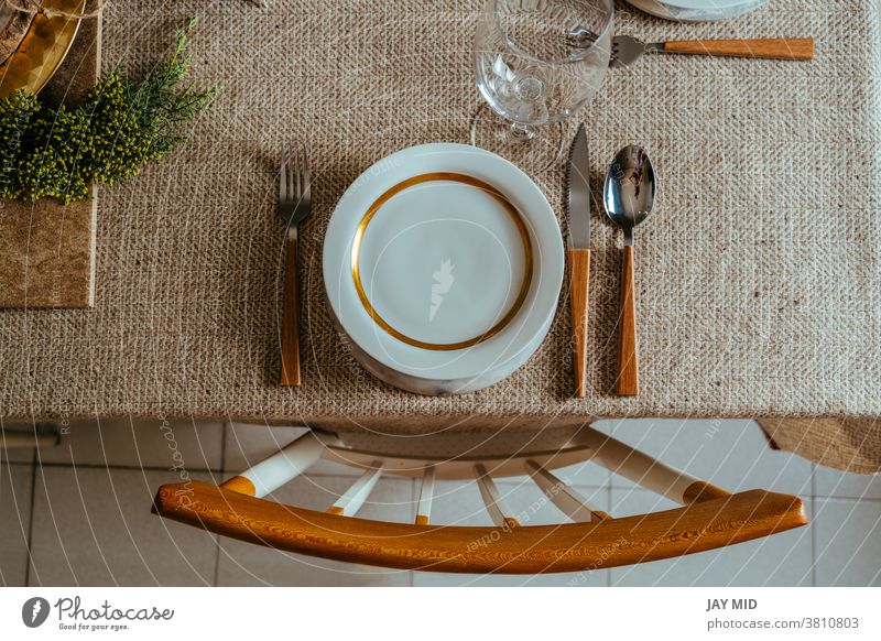 Holiday Gold place setting,  Christmas table with ornaments and natural pine branch on the livingroom home christmas thanksgiving menu food happy above