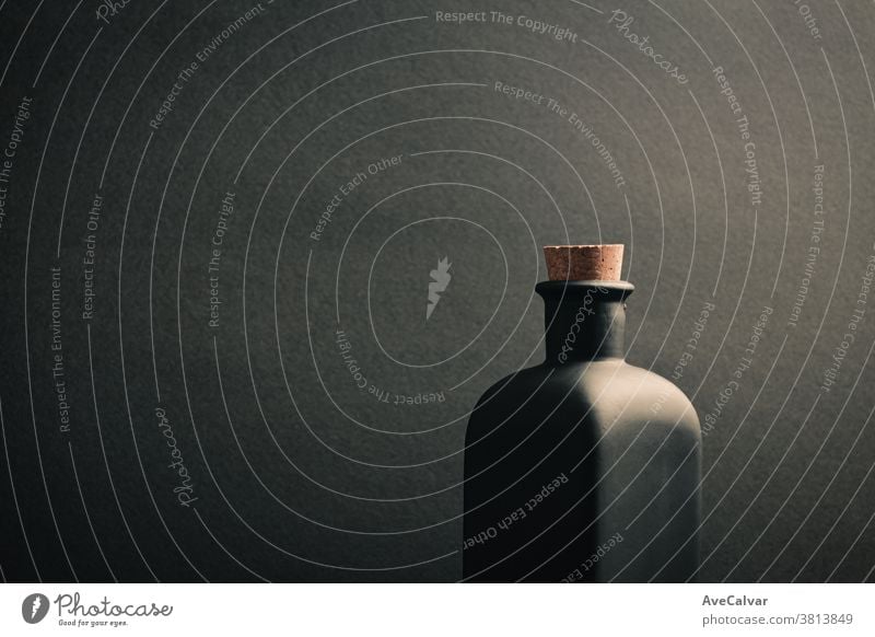 A close up of a black ceramic bottle with a dark background mock-up gin scotch rum irish trendy brandy design matte space malt black background object cream