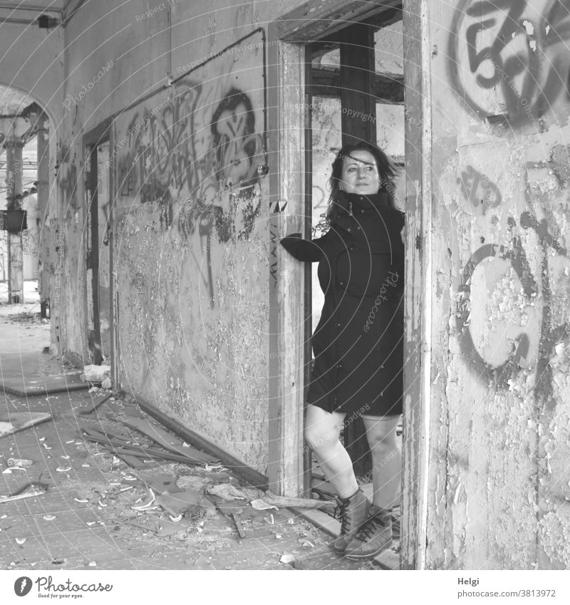 for bitti - long-haired woman in black coat standing in a doorway of an old dilapidated building Human being Woman Building lost place Wall (building) Doorframe