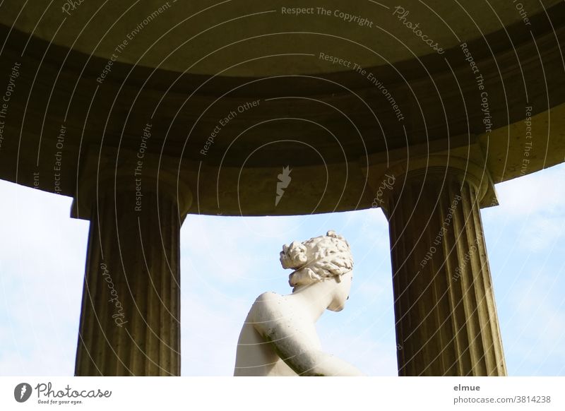 The Roman goddess of love and beauty in the temple of Venus looks somewhat embarrassed into the distance. Goddess Temple of Venus Statue averted partial view