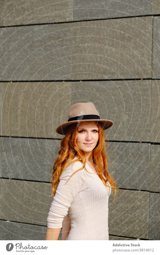 Smiling redhead woman in hat style smile trendy red hair urban modern positive young female fashion long hair lady confident charming lifestyle cheerful elegant