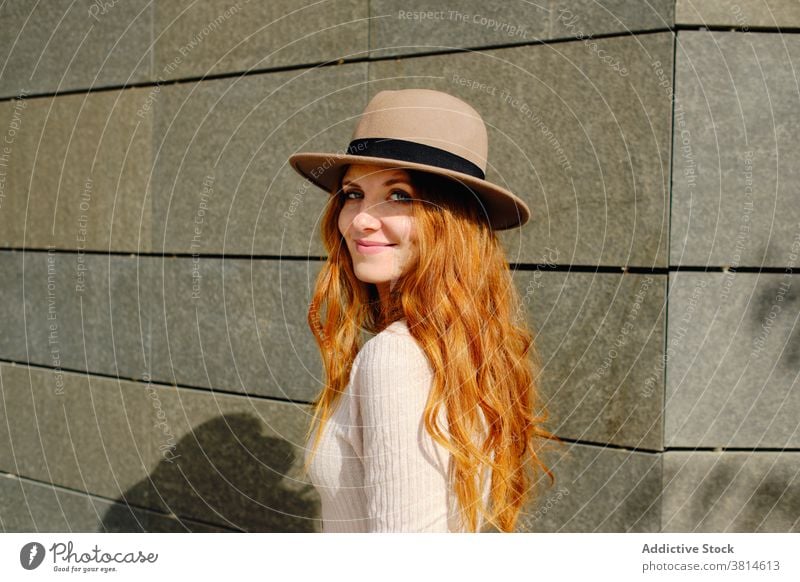 Smiling redhead woman in hat style smile trendy red hair urban modern positive young female fashion long hair lady confident charming lifestyle cheerful elegant