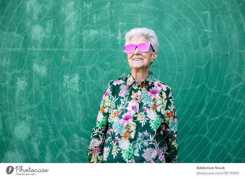 Stylish elderly woman in trendy sunglasses senior style hipster cool colorful outfit female fashion urban lifestyle bright individuality crazy happy cheerful