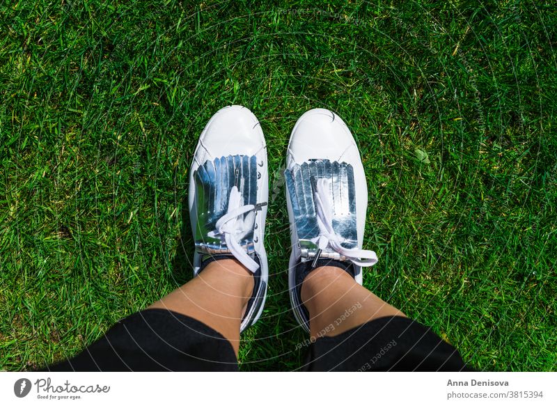 Yound Woman in White Sneakers, Top View white sneakers shoes fashion wear style foot legs hiking sport jeans street grass park walking above top view selfie