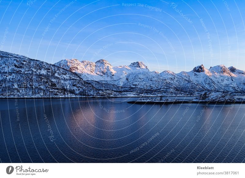 Norway - Trollfjord , Lofoten mountains rise into the blue almost cloudless sky at the beginning of sunset Lofotes Vacation & Travel Ocean Maritime experience