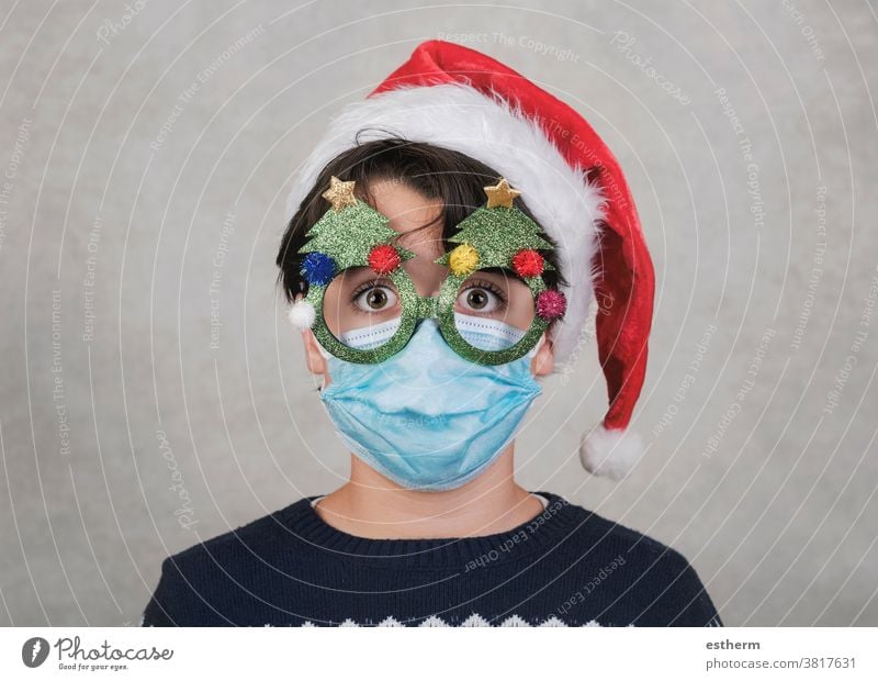 Merry Christmas, Funny child with medical mask and funny christmas glasses santa claus coronavirus Christmas Eve 2019-ncov epidemic covid-19 pandemic quarantine
