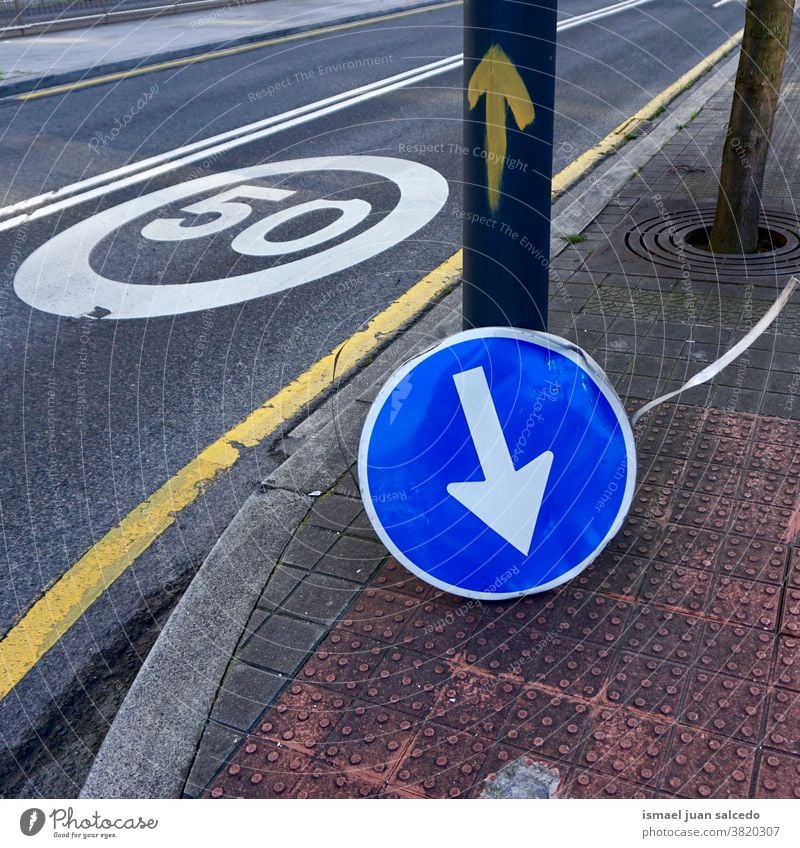 broken arrow traffic signal on the street in Bilbao city Spain direction obligation compulsory road asphalt warning road sign symbol way caution roadsign advice